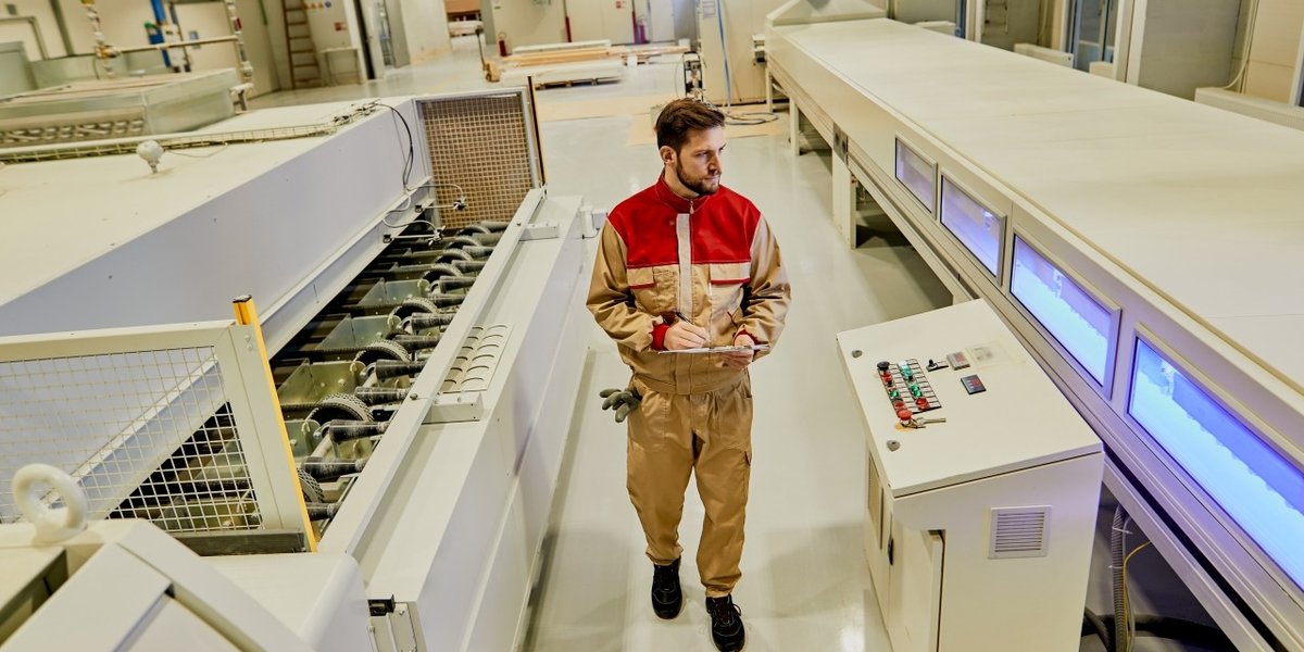 wp-151843a6b3288262-industrial-worker-supervising-automated-machines-while-walking-through-woodworki