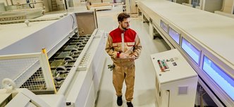 wp-151843a6b3288262-industrial-worker-supervising-automated-machines-while-walking-through-woodworki