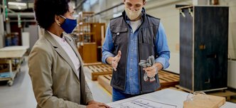 wp-15433280da424366-male-carpenter-explaining-design-plans-african-american-female-manager-productio