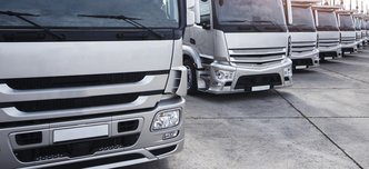 wp-2c091776f5d1bf9c-group-trucks-parked-row