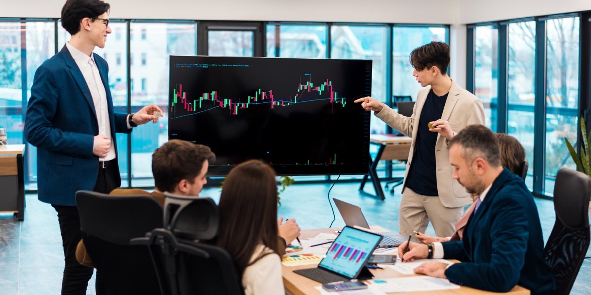 wp-2fb528ecd58958ac-two-young-worker-leading-business-meeting-about-cryptocurrencies-office