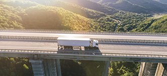 wp-3e7f7a13a50fc09e-trucks-highway-mountain-sunset