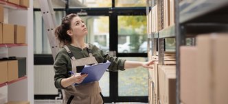 wp-5644aae3e7953f67-warehouse-employee-counting-cardboard-boxes