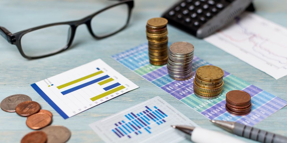 wp-5a66700cb9a4b8d3-reading-glasses-piles-coins-high-view