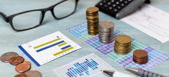 wp-5a66700cb9a4b8d3-reading-glasses-piles-coins-high-view