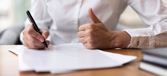 wp-78a519f1f44322a1-woman-writing-showing-thumbs-up (1)