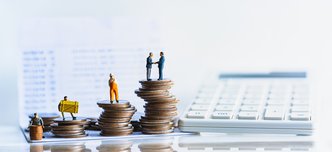 wp-8fa899ff4b3af81c-Miniature,People,Standing,On,A,Pile,Of,Coins.,Inequality,And