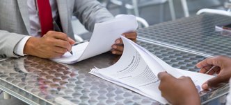 wp-920fbc6ce491e326-business-partners-checking-signing-document