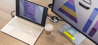 wp-9722e3e61d827a27-Laptop,And,Monitor,Displaying,Colorful,Vr,Graphs,On,Wooden,Desk