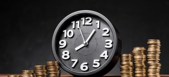 wp-a9bec136c8ae555d-round-clock-increasing-coins-wooden-desk-against-black-backdrop