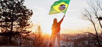 wp-b8546cb54bab81ca-woman-holding-brazilian-flag-full-shot