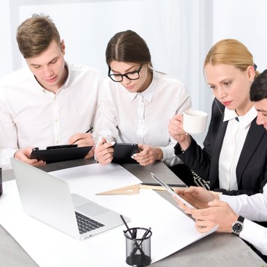 wp-f8f046d4c5ea6c61-creative-businesspeople-with-mobile-laptop-digital-tablet-working-together-offic